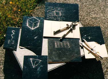 [JPG: PHOTO OF VARIOUS HAND-DRAWN HOLOGRAMS IN THE SUN]